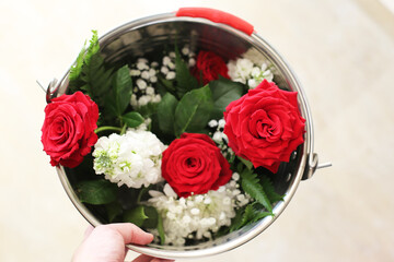 a Beautiful Red Rosses flower in a vintage bucket.