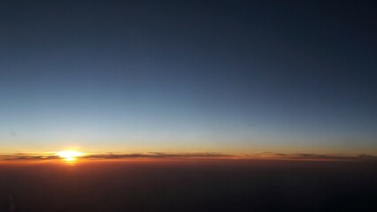 breathtaking sunset view above the sky from a plane on the way to vacation