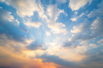 sunset / sun rise sky with rays of  light shining clouds and sky background and texture