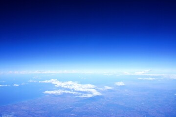Fototapeta na wymiar breathtaking view from the plane on the earth from above to the horizont and the blue sky
