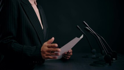 Hands of female teacher holding paper, reading lecture to students, education