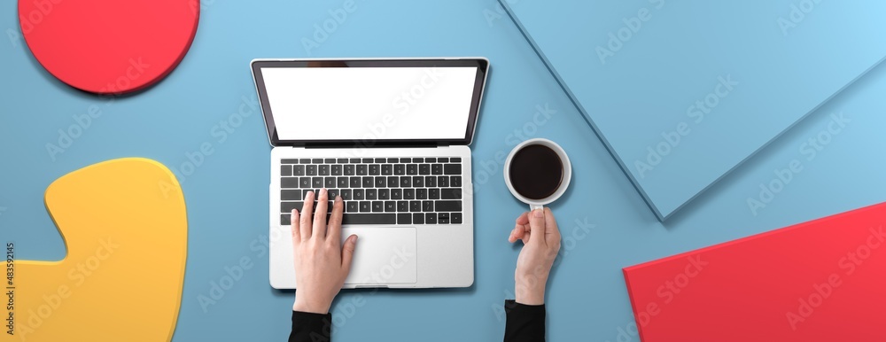Poster person using a laptop computer with geometric shaped objects from above