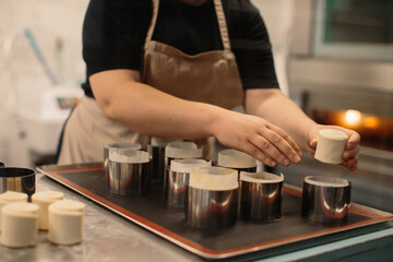 Woman baker prepares kraffins in the bakery.