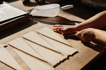 Female Hands Rolling Dough into Rolls, Baking Process Making Croissant. Selected Focus, Concept for Bakery