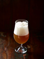 Glass of Wheat Beer on dark wooden background. Copy space.	
