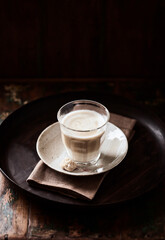 Coffee with milk on dark background. Soft focus. Copy space.