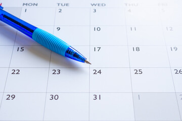 Blue pen on calendar page background business planning appointment meeting concept