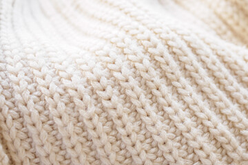 Fototapeta na wymiar closeup beige knitted woolen fabric texture background