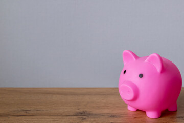 pink piggy bank on a wooden table, copyspace. Finance, savings. Business