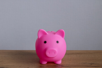 pink piggy bank on a wooden table, copyspace. Finance, savings. Business