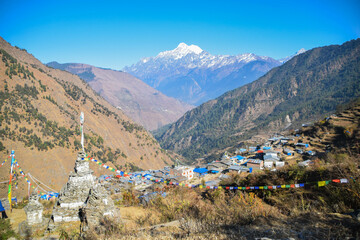 Houses of the village Gatlang in Nepal with a stupa in the foreground. Tamang Heritage Trail and Langtang trek day 1 from Syabrubesi to Gatlang
