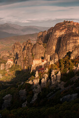 Atmospheric distant view of the Monastery of Rousanou Agias Barbaras in Meteora. Tourist and pilgrimage inspirations. Natural and religious wonders of Greece.