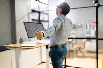 Man Doing Stretch Exercise At Work