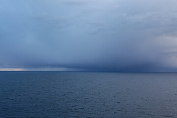 Obraz premium Dark storm cloud on the sea horizon