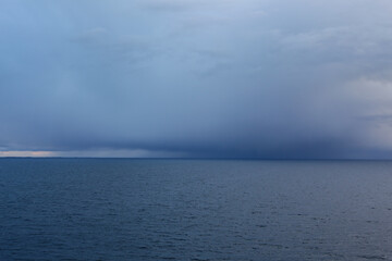 Dark storm cloud on the sea horizon