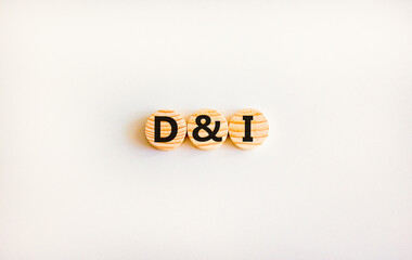 D and I, Diversity and inclusion symbol. Concept words D and I, diversity and inclusion on wooden circles on beautiful white background. Business, D and I, diversity and inclusion concept.