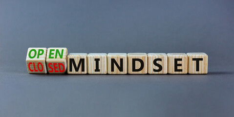 Open or closed mindset symbol. Turned wooden cubes and changed concept words closed mindset to open mindset. Beautiful grey background, copy space. Business open or closed mindset concept.