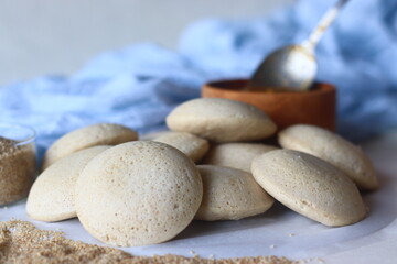 Fototapeta na wymiar Steamed Little millet cakes or little millet idli. Made with a fermented batter of little millet, lentils. Shot with little millet in a wooden bowl
