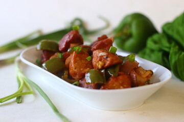 Idli Manchurian. An Indo Chinese fusion food made with leftover idlis, capsicum and spring onions....