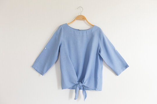 blue blouse on hanger.