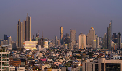 Naklejka premium Aerial view of Sathorn, Bangkok Downtown skyline. Financial district and business centers in smart urban city town in Asia. Skyscraper and high-rise buildings at night.