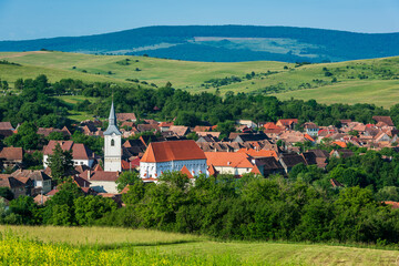 View to the village with fortified church, Darjiu, Transylvania, Romania - 483603120