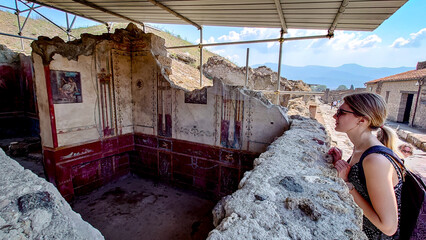 women in Pompeii, looking to rouins of ancient city, Italy