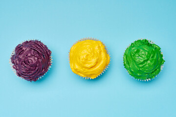 Mardi Gras cupcakes with traditional colored frosting.