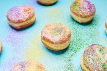 Donuts sprinkled with traditional Mardi Gras colors of green, purple, and gold.