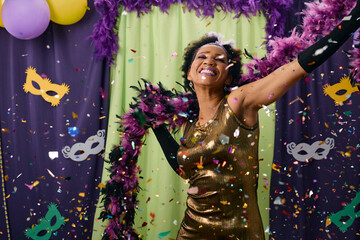 Carefree black woman celebrates Mardi Gras and dances on a party. - obrazy, fototapety, plakaty