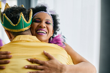 Happy black woman embraces her friend during Mardi Gras celebration party.