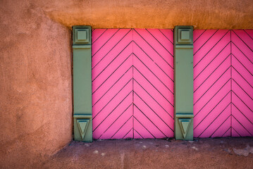 pink doors on adobe building