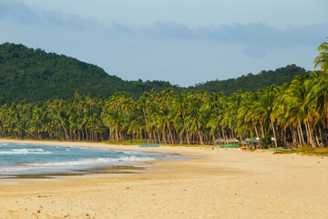Fototapeta na wymiar Seascape. Tropical climate. Sea and sand. Deserted beach. Philippines. Ocean shore.