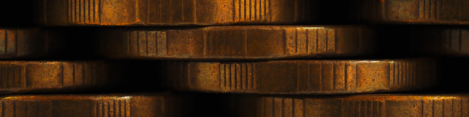 Stacks of coins closeup. Money textured banner. Dark brown business headline made of many coin edges. Russian tens. Economics finance and banking. Macro