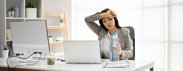 Thirsty Person Working At Desk With Bottle
