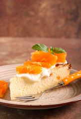 Slice of citrus cheesecake with cream