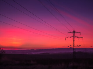Electricity lines at dramatic sunset. .