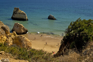 Praia dos Tres Irmaos Beach between the yellow cliffs with sand areas in Portimao, algarve, portugal 