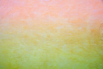 concrete wall structured with spatula technique, toned in pink yellow and green