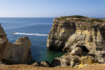 Fototapeta na wymiar yellow cliff, sand and clear water at the Carvalho cape, Algarve, Portugal