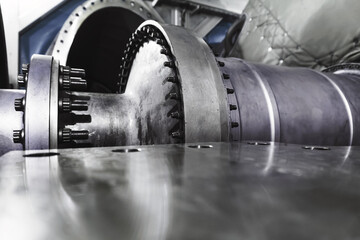 A gas turbine with a compressor rotor and a bolted coupling half