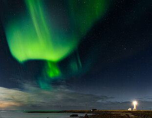 Aurora Borealis displaying above Grotta Island lighthouse in the city of Reykjavík, Iceland