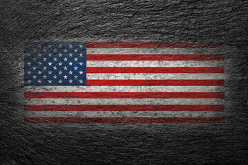 USA flag. American flag is painted on a black stone. Creative background. 
