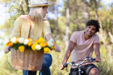 young smiling couple riding bicycles