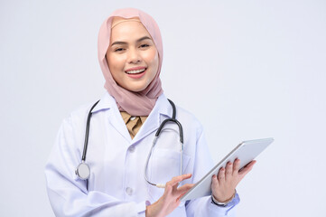 Female muslim doctor with hijab over white background studio.