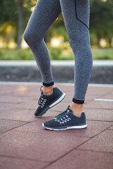 Athlete girl legs shod in running shoes