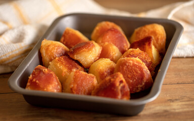 A tray of crispy golden roast potatoes
