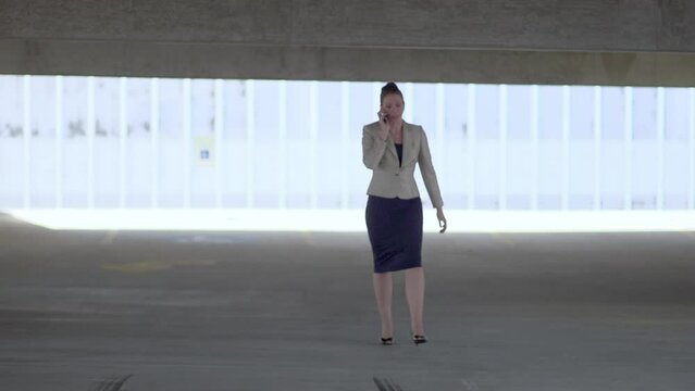 Businesswoman on phone in parking deck