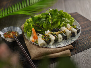 Grilled Beef La Lot Wrapped in Betel Leaf salad in a plate on dark background, Vietnamist food
