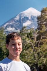 Portrait of a child in nature with a volcano in the background.